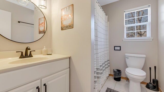 full bath featuring curtained shower, toilet, vanity, and tile patterned flooring