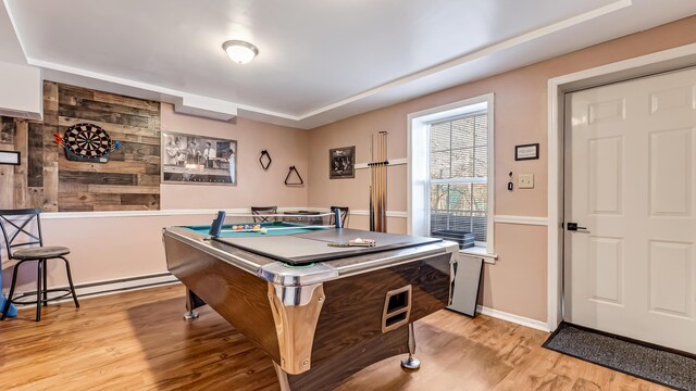 rec room with baseboard heating and light wood-style flooring