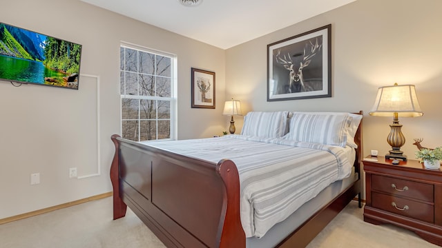 bedroom featuring visible vents, baseboards, and light colored carpet