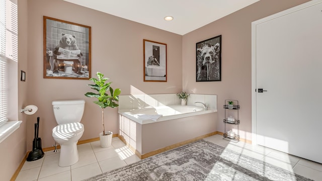 full bathroom featuring a bath, baseboards, recessed lighting, tile patterned floors, and toilet