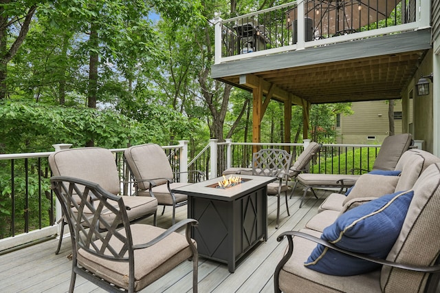 wooden deck with an outdoor living space with a fire pit