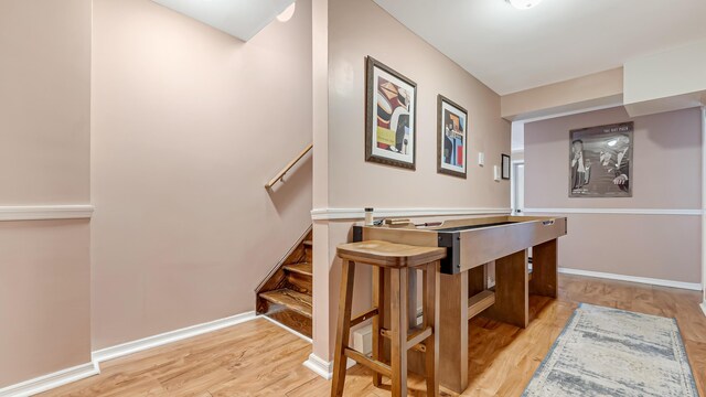 interior space featuring baseboards and wood finished floors