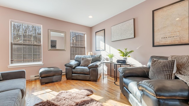 living room with light wood-style flooring, recessed lighting, and a baseboard radiator