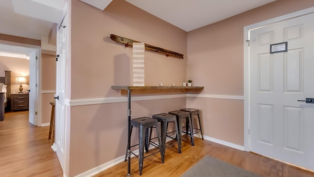 bar with baseboards and wood finished floors