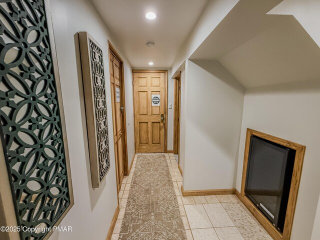 corridor featuring light tile patterned flooring