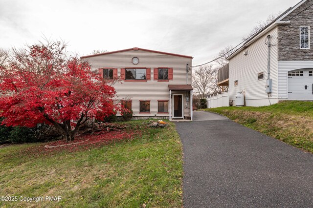 view of front facade with a garage and a front yard