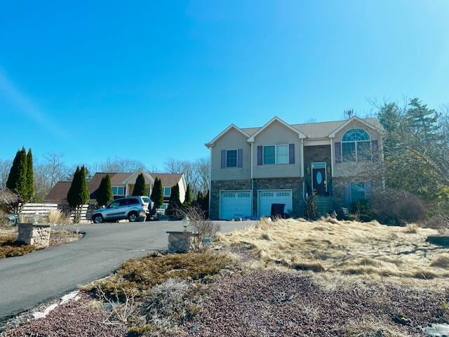 split foyer home with an attached garage and driveway