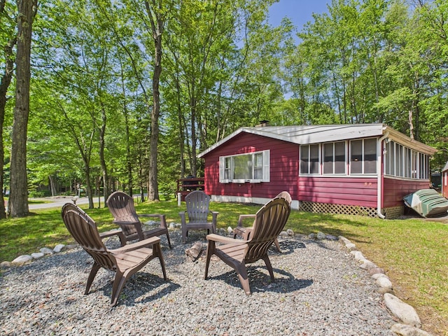 105 Buffalo Trl, Pocono Lake, PA 18347 - view of grassy yard featuring a sunroom and a fire pit