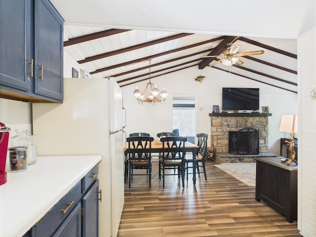 105 Buffalo Trl, Pocono Lake, PA 18347 - dining area with ceiling fan, dark wood finished floors, a fireplace, and a chandelier