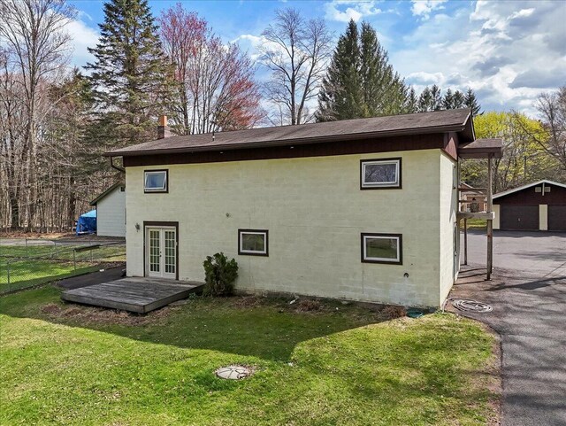 253 Thomas Rd, Blakeslee, PA 18610 - rear view of house with french doors, an outdoor structure, a shingled roof, and a garage