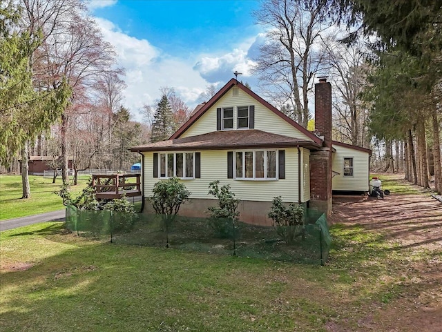 253 Thomas Rd, Blakeslee, PA 18610 - view of property exterior featuring a chimney, a lawn, and a deck