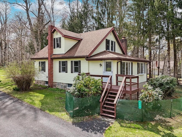 253 Thomas Rd, Blakeslee, PA 18610 - view of front facade with a chimney, stairs, a wooden deck, a shingled roof, and a front lawn