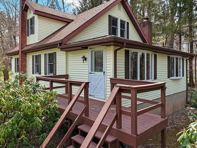 253 Thomas Rd, Blakeslee, PA 18610 - view of front facade with a chimney, a deck, and a shingled roof