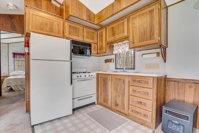 253 Thomas Rd, Blakeslee, PA 18610 - kitchen with white appliances, light countertops, light flooring, a sink, and a wainscoted wall