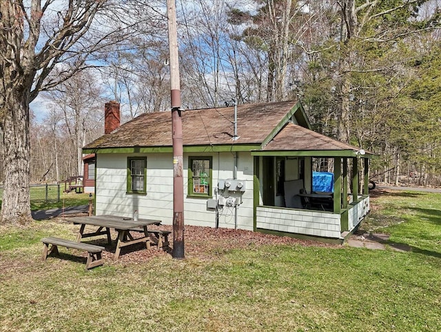 253 Thomas Rd, Blakeslee, PA 18610 - view of property exterior featuring a chimney, a yard, and a shingled roof