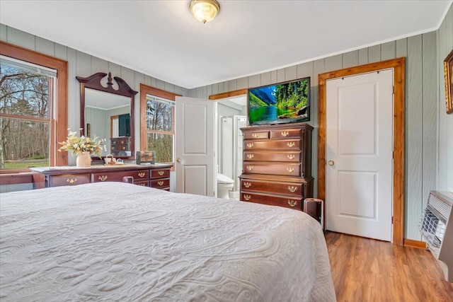 253 Thomas Rd, Blakeslee, PA 18610 - bedroom with ornamental molding, wood finished floors, wooden walls, and heating unit