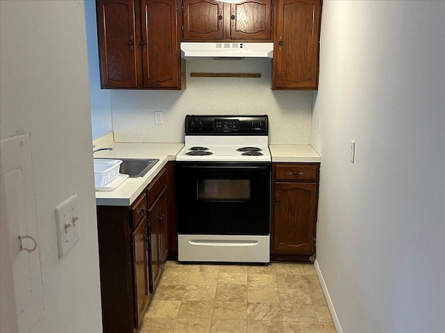 253 Thomas Rd, Blakeslee, PA 18610 - kitchen with electric range oven, under cabinet range hood, a sink, light countertops, and baseboards