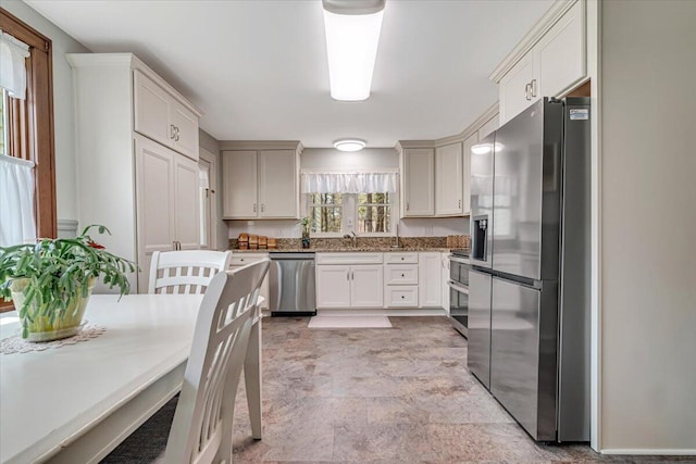 253 Thomas Rd, Blakeslee, PA 18610 - kitchen with appliances with stainless steel finishes, a sink, stone countertops, and white cabinetry