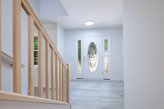 4105 Arbutus Dr Unit 1200, Tobyhanna, PA 18466 - entryway featuring wood finished floors, a textured ceiling, baseboards, and stairway
