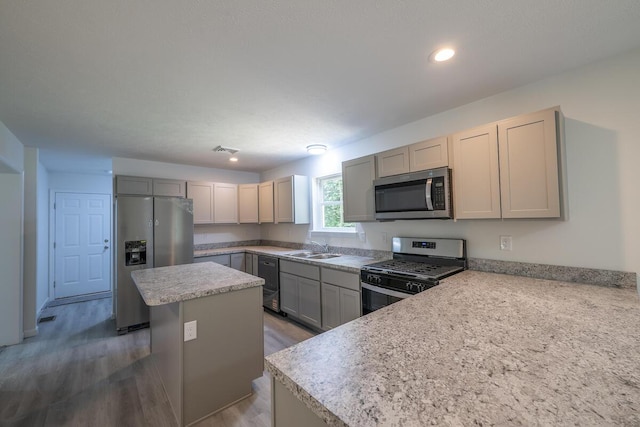 4105 Arbutus Dr Unit 1200, Tobyhanna, PA 18466 - kitchen with appliances with stainless steel finishes, a sink, a kitchen island, light countertops, and wood finished floors