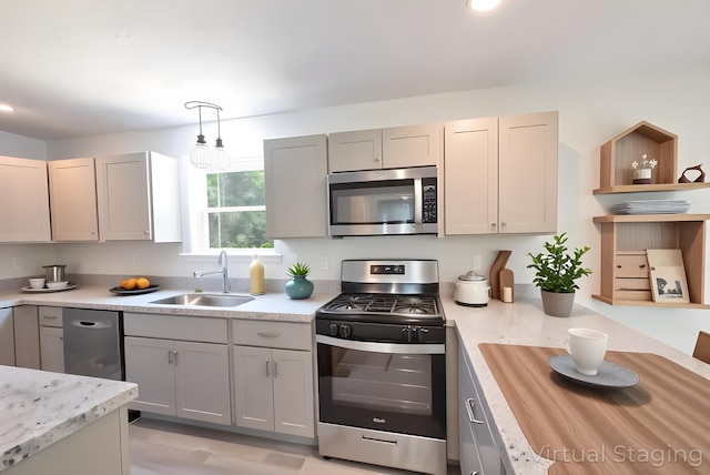 4105 Arbutus Dr Unit 1200, Tobyhanna, PA 18466 - kitchen with stainless steel appliances, a sink, pendant lighting, and gray cabinets