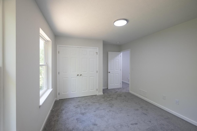 4105 Arbutus Dr Unit 1200, Tobyhanna, PA 18466 - unfurnished bedroom with multiple windows, carpet flooring, baseboards, and a closet