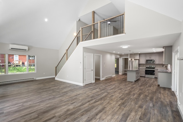 21 Wilde Gln, Albrightsville, PA 18210 - unfurnished living room with high vaulted ceiling, a wall mounted air conditioner, dark wood finished floors, a baseboard radiator, and stairway