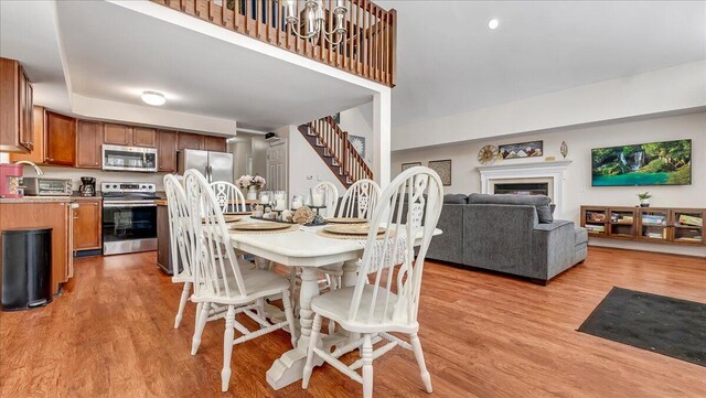 186 Brier Crest Rd, Blakeslee, PA 18610 - dining space with light wood-style flooring, stairway, and a fireplace