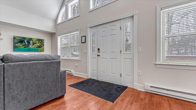 186 Brier Crest Rd, Blakeslee, PA 18610 - foyer entrance with a baseboard heating unit, wood finished floors, lofted ceiling, and baseboards