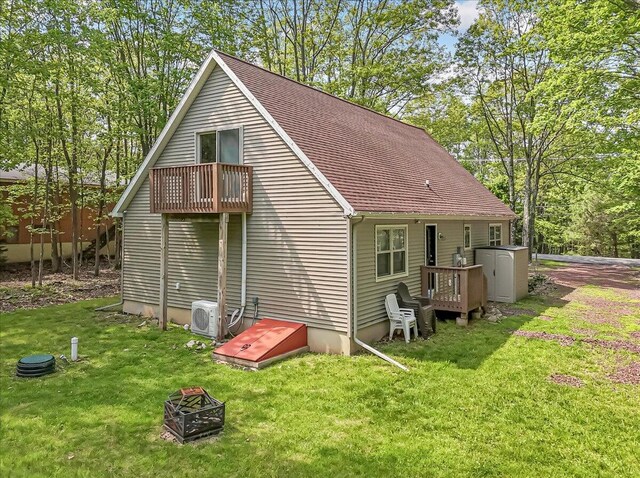 186 Brier Crest Rd, Blakeslee, PA 18610 - back of house featuring a balcony, a cooling unit, a yard, and a fire pit