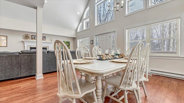 186 Brier Crest Rd, Blakeslee, PA 18610 - dining space with high vaulted ceiling, light wood-style flooring, and a fireplace
