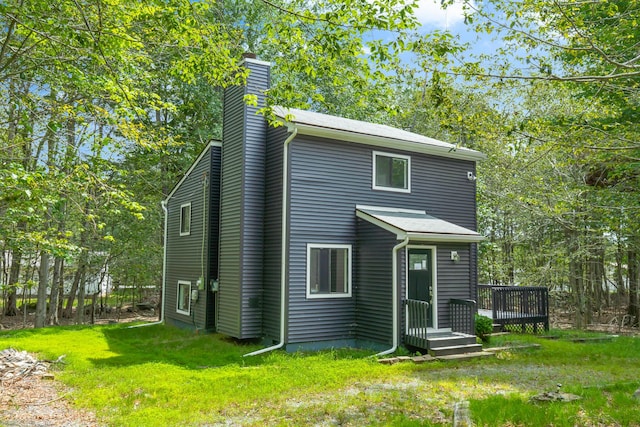 view of front of house featuring a front yard and a chimney