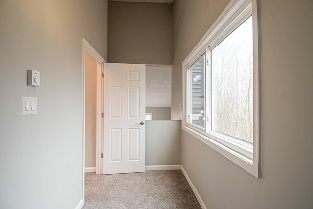 unfurnished room featuring baseboards and carpet
