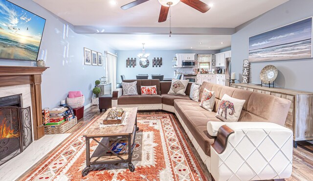 6435 Marvin Gdns, Tobyhanna, PA 18466 - living area featuring ceiling fan, a chandelier, a fireplace, light wood-style floors, and recessed lighting