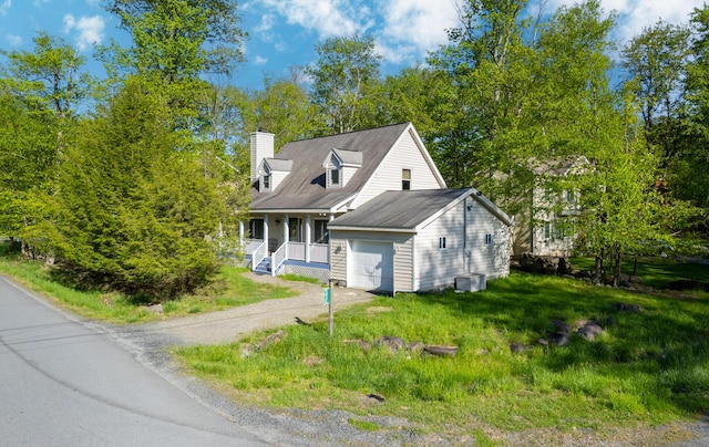 6435 Marvin Gdns, Tobyhanna, PA 18466 - cape cod house with covered porch, an attached garage, driveway, a chimney, and central AC