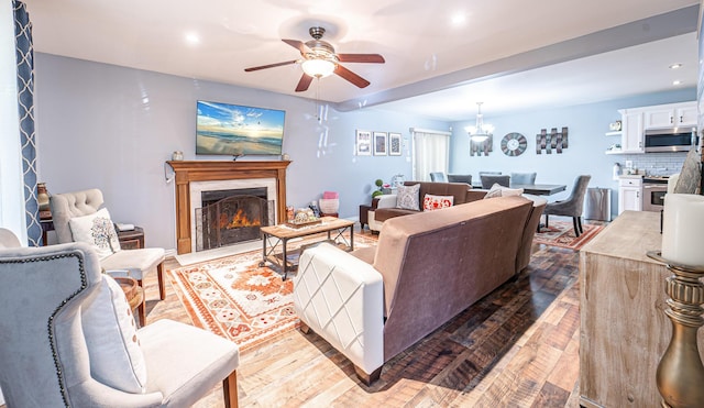 6435 Marvin Gdns, Tobyhanna, PA 18466 - living area featuring a ceiling fan, a high end fireplace, recessed lighting, wood finished floors, and a chandelier