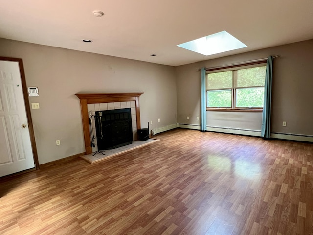 125 Ponder Ln, Scotrun, PA 18355 - unfurnished living room with a skylight, wood finished floors, a fireplace, and baseboards