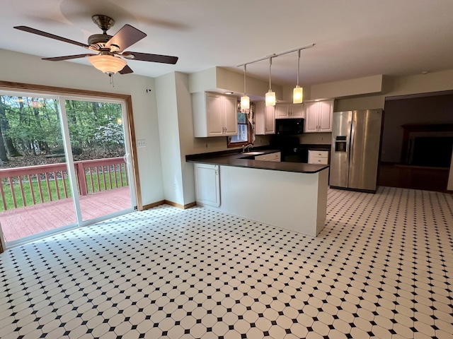 125 Ponder Ln, Scotrun, PA 18355 - kitchen with stainless steel fridge, black microwave, dark countertops, a peninsula, and baseboards