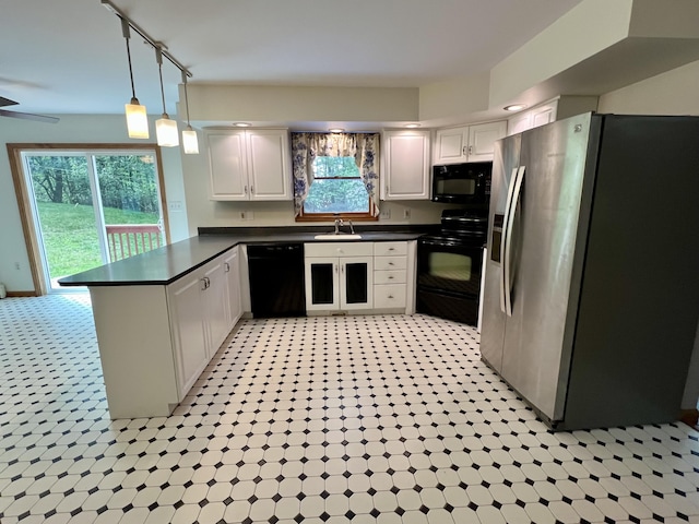 125 Ponder Ln, Scotrun, PA 18355 - kitchen with black appliances, a peninsula, a sink, dark countertops, and white cabinets