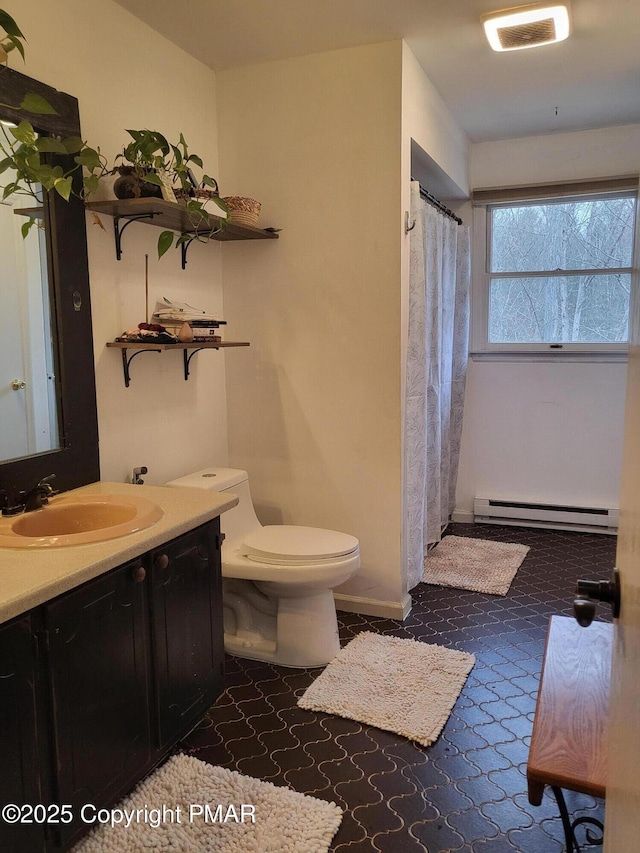 bathroom featuring visible vents, toilet, baseboard heating, vanity, and a shower with curtain