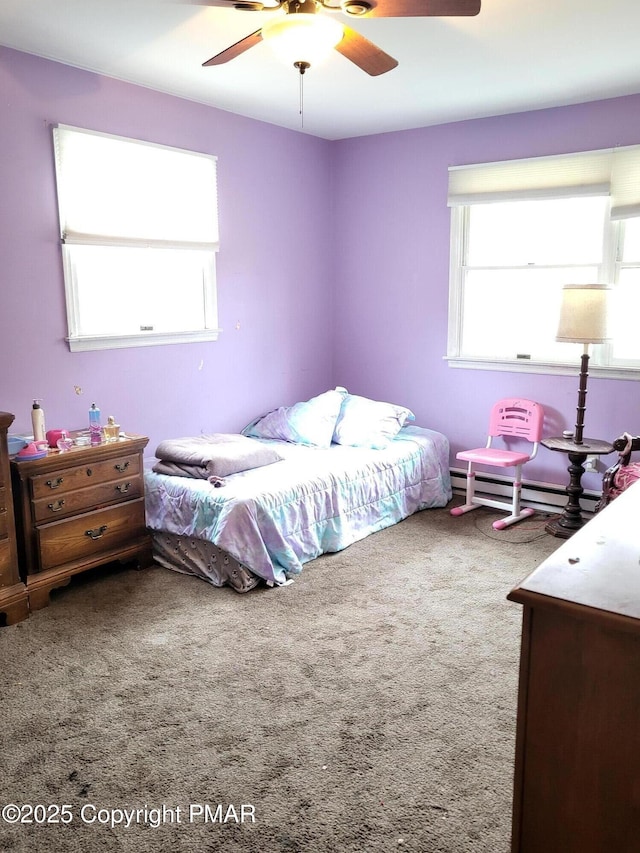 carpeted bedroom with a ceiling fan and a baseboard heating unit