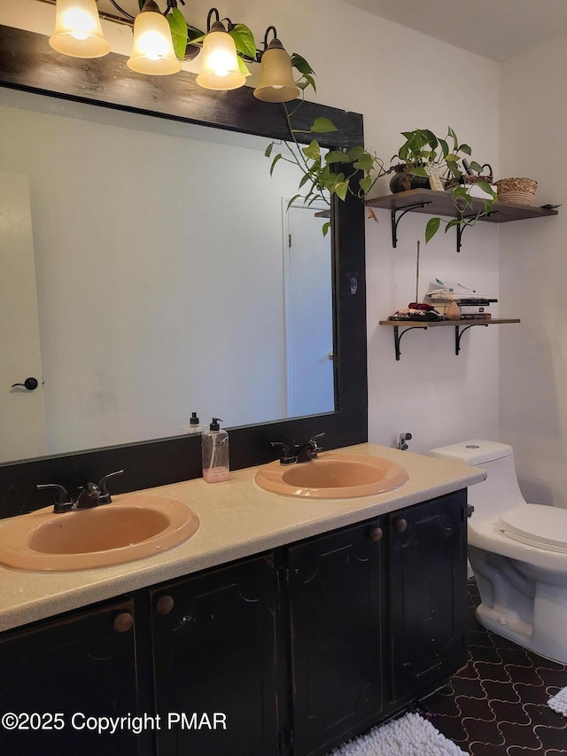 full bath with double vanity, a sink, and toilet