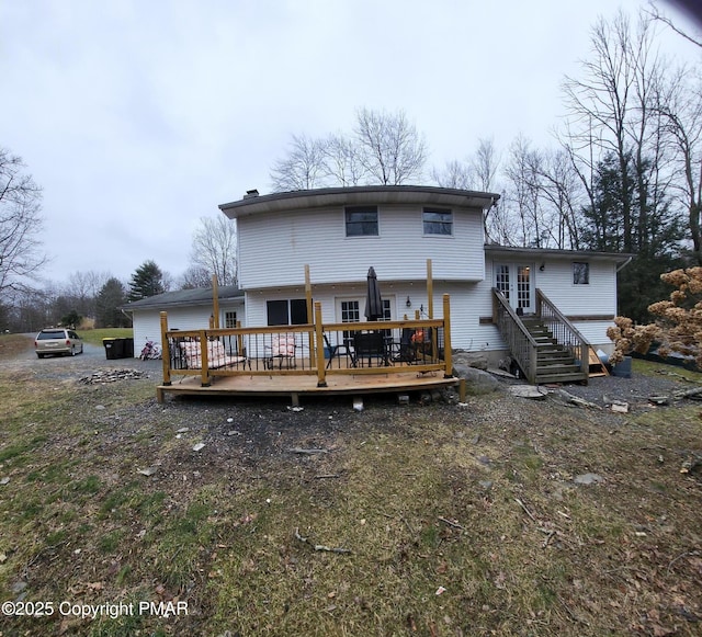 rear view of house featuring a wooden deck