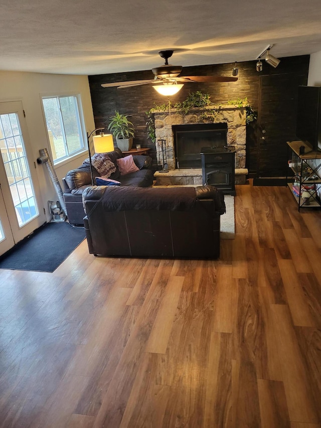 living area with wood finished floors and a ceiling fan