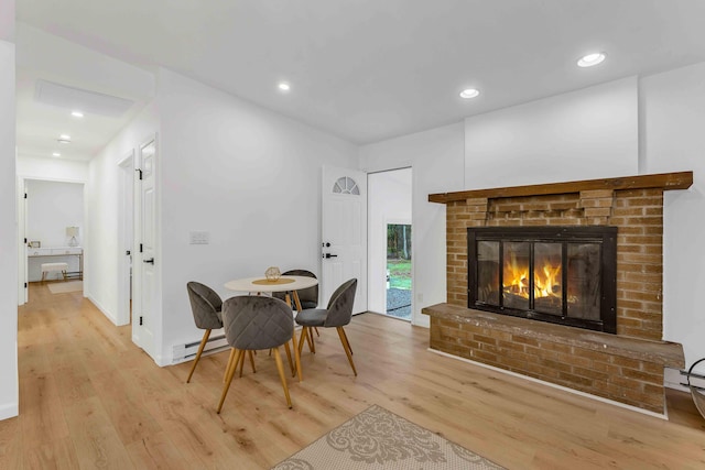 19 Mckinley Ln, Albrightsville, PA 18210 - dining space with light wood-style flooring, a brick fireplace, a baseboard heating unit, and recessed lighting