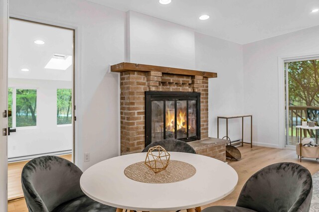 19 Mckinley Ln, Albrightsville, PA 18210 - dining room with wood finished floors, a fireplace, a baseboard heating unit, and recessed lighting