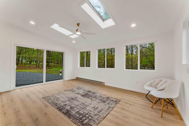 19 Mckinley Ln, Albrightsville, PA 18210 - living area featuring a skylight, a baseboard radiator, plenty of natural light, vaulted ceiling, and wood finished floors