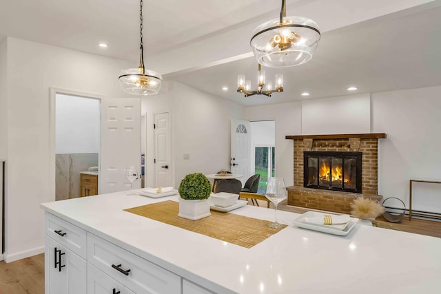 19 Mckinley Ln, Albrightsville, PA 18210 - kitchen with white cabinetry, light wood-style flooring, light countertops, recessed lighting, and a brick fireplace