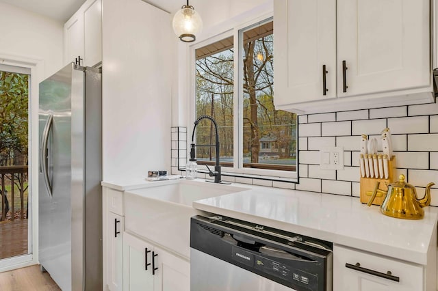 19 Mckinley Ln, Albrightsville, PA 18210 - kitchen featuring appliances with stainless steel finishes, backsplash, light countertops, and white cabinetry