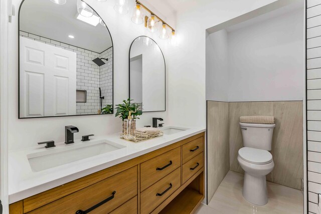 19 Mckinley Ln, Albrightsville, PA 18210 - full bathroom with toilet, double vanity, a tile shower, tile patterned flooring, and tile walls